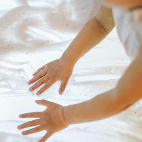 Image of kids hand in sand